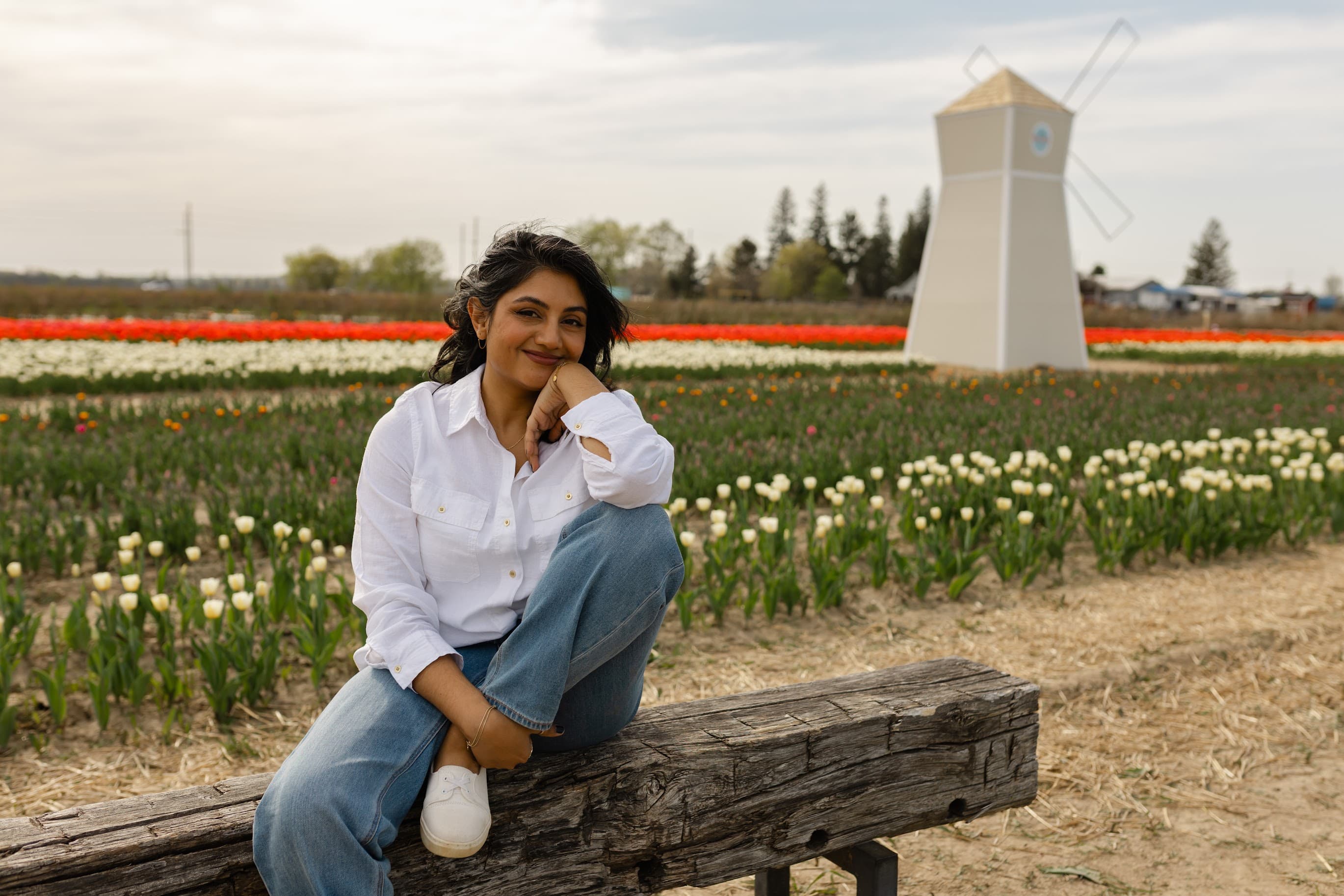 Dr. Anne Hussain relaxing in a tulip field
